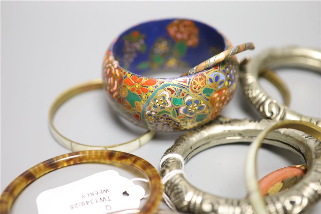 A collection of bangles, including five ethnic white metal examples,
